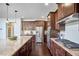 Gourmet kitchen featuring stainless steel appliances, granite countertops, and dark cabinetry at 1808 Capstone Dr, Durham, NC 27713