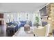 Bright living room with large blue sectional, fireplace, and lots of natural light at 1808 Capstone Dr, Durham, NC 27713
