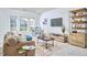 Spacious living room with a comfortable couch, large windows, and modern decor at 1808 Capstone Dr, Durham, NC 27713