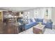 Open-concept living room with hardwood floors and blue sofa near the island and kitchen at 1808 Capstone Dr, Durham, NC 27713