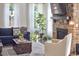 Well-lit living room with stone fireplace, fiddle leaf fig, and comfortable seating at 1808 Capstone Dr, Durham, NC 27713