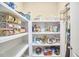 Walk-in pantry with shelving stocked with food and cooking supplies at 1808 Capstone Dr, Durham, NC 27713