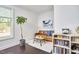 Sitting area with a leather couch, bookshelf, and a window view at 1808 Capstone Dr, Durham, NC 27713