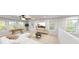 Spacious living room with large windows, a sectional sofa, and a recreational game table at 1891 Ballard Rd # 192, Fuquay Varina, NC 27526