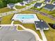 Aerial view of community pool area with lounge chairs and umbrellas surrounded by homes in the neighborhood at 1891 Ballard Rd # 192, Fuquay Varina, NC 27526