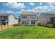 Back exterior of home with spacious well-manicured lawn, and a fenced in yard at 1908 Woodsdale Dr, Durham, NC 27703