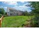 Beautiful backyard featuring a well-maintained lawn and a charming two-story house with many windows at 1908 Woodsdale Dr, Durham, NC 27703