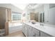 Bathroom featuring double sinks, a large tub, and tile flooring at 1908 Woodsdale Dr, Durham, NC 27703