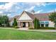 View of the clubhouse with a well-manicured lawn and decorative awnings at 1908 Woodsdale Dr, Durham, NC 27703