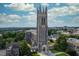 Stunning aerial view of Duke Chapel's gothic architecture and lush green surroundings under a bright blue sky at 1908 Woodsdale Dr, Durham, NC 27703
