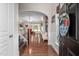 Bright foyer featuring hardwood floors, staircase, and an arched entryway to the living room at 1908 Woodsdale Dr, Durham, NC 27703
