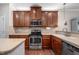 Modern kitchen with stainless steel appliances, granite countertops, and wood cabinetry at 1908 Woodsdale Dr, Durham, NC 27703