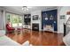 Cozy living room featuring a fireplace, hardwood floors, and large windows for ample natural light at 1908 Woodsdale Dr, Durham, NC 27703