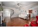 Bright living room featuring hardwood floors, white sofa, archways, and a modern ceiling fan at 1908 Woodsdale Dr, Durham, NC 27703