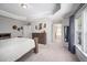 Bright main bedroom with natural light and a glimpse into the luxurious bathroom at 1908 Woodsdale Dr, Durham, NC 27703