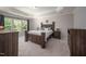 Spacious main bedroom with a large window, neutral colors, and tray ceiling at 1908 Woodsdale Dr, Durham, NC 27703