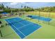Aerial view of the community's well-maintained tennis courts and surrounding greenery at 1908 Woodsdale Dr, Durham, NC 27703