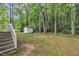 The green backyard features a storage shed and is surrounded by tall trees at 196 Marlin Ln, Smithfield, NC 27577
