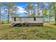 The home features white siding, with a staircase that leads into the green backyard at 196 Marlin Ln, Smithfield, NC 27577