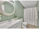 Bathroom featuring a vanity, round mirror, and shower with a white curtain at 196 Marlin Ln, Smithfield, NC 27577