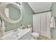 Bathroom features a vanity, round mirror, and shower with a white curtain at 196 Marlin Ln, Smithfield, NC 27577