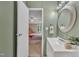Bathroom featuring a vanity, round mirror, and an en-suite view into the bedroom at 196 Marlin Ln, Smithfield, NC 27577