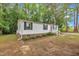 Charming single-story home featuring white siding, black shutters, and a welcoming red front door at 196 Marlin Ln, Smithfield, NC 27577