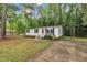 Charming single-story home featuring white siding, black shutters, and a welcoming red front door at 196 Marlin Ln, Smithfield, NC 27577