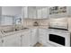 Bright kitchen with white cabinets, subway tile backsplash, and modern appliances and accessories at 196 Marlin Ln, Smithfield, NC 27577