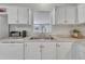 Charming kitchen featuring white cabinets, subway tile backsplash, and modern stainless steel appliances at 196 Marlin Ln, Smithfield, NC 27577