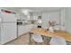 Bright kitchen features white cabinets, appliances, and a wood table with chairs at 196 Marlin Ln, Smithfield, NC 27577