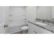 Bright bathroom featuring a tub with shower, white vanity and granite countertops at 203 Benton Dr, Oxford, NC 27565