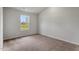 A cozy bedroom features plush carpet, a bright window, and neutral wall, creating a serene atmosphere at 203 Benton Dr, Oxford, NC 27565