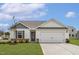 Charming single-story home featuring a well-maintained lawn, two car garage, and welcoming front entrance at 203 Benton Dr, Oxford, NC 27565