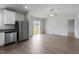 Open-concept living space featuring modern flooring, a ceiling fan, and sliding glass doors to the backyard at 203 Benton Dr, Oxford, NC 27565