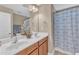 Bathroom featuring double sinks, wood cabinets, and a shower tub at 205 Forbes Rd, Wake Forest, NC 27587