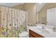 Cozy bathroom featuring a shower with floral curtains and wood vanity at 205 Forbes Rd, Wake Forest, NC 27587