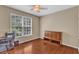 Bright bedroom with hardwood floors, a window, a ceiling fan, and a built-in cabinet at 205 Forbes Rd, Wake Forest, NC 27587