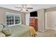 Bedroom with ceiling fan, wood furniture, and large window view at 205 Forbes Rd, Wake Forest, NC 27587