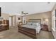 Bright bedroom featuring a ceiling fan, dresser, and sitting area with a chair at 205 Forbes Rd, Wake Forest, NC 27587