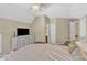 Bedroom with a TV, and adjacent bathroom, hallway, and staircase entrances at 205 Forbes Rd, Wake Forest, NC 27587