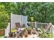 View of the outdoor deck featuring patio furniture and a grill with green foliage in the background at 205 Forbes Rd, Wake Forest, NC 27587