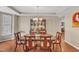 Formal dining room with hardwood floors, a classic chandelier, and ample seating for Gathering gatherings at 205 Forbes Rd, Wake Forest, NC 27587