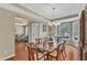 Well-lit dining room showcasing hardwood floors, a chandelier, and an open view of the entry and living spaces at 205 Forbes Rd, Wake Forest, NC 27587