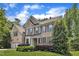 Beautiful two-story brick home boasting manicured landscaping, an attached two-car garage, and classic shuttered windows at 205 Forbes Rd, Wake Forest, NC 27587