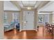 Bright foyer with hardwood floors, tray ceiling, and natural light pouring through the front door and windows at 205 Forbes Rd, Wake Forest, NC 27587