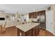 Open kitchen with granite island, stainless steel appliances, and wood cabinets at 205 Forbes Rd, Wake Forest, NC 27587