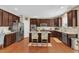Modern kitchen with stainless steel appliances, granite countertops, and a central island with a stainless steel refrigerator at 205 Forbes Rd, Wake Forest, NC 27587