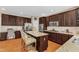 Open kitchen with stainless steel appliances, granite countertops, and a center island with bar stool seating at 205 Forbes Rd, Wake Forest, NC 27587