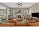 Cozy living room with a fireplace, large windows, and comfortable seating for relaxing or entertaining guests at 205 Forbes Rd, Wake Forest, NC 27587